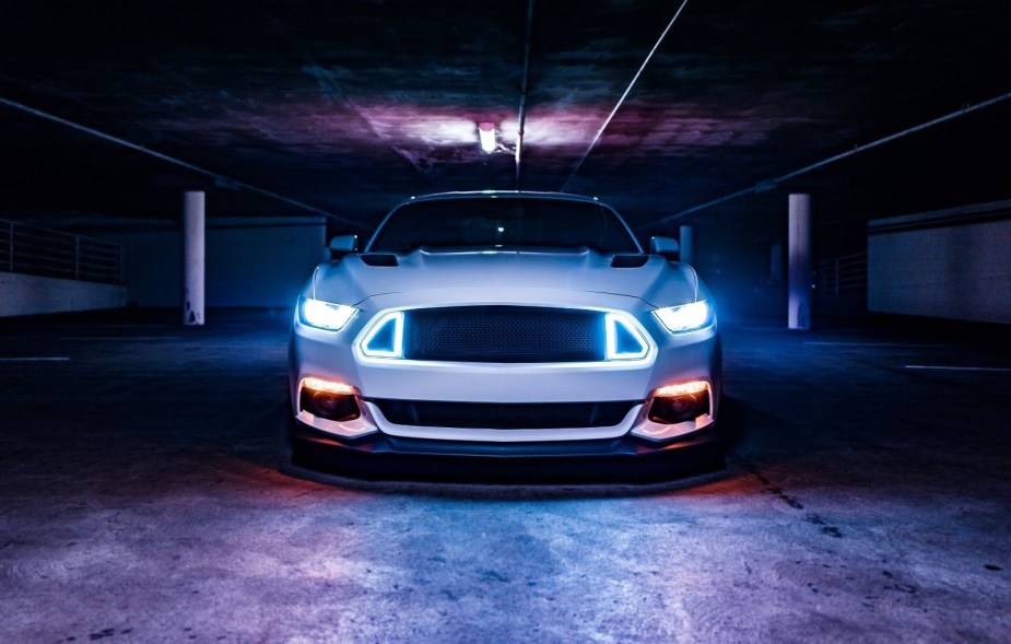 Headlights shining on a white car, highlighting when to use and not to use high beam and low beam headlights