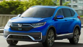 A blue 2022 Honda CR-V is driving on the road.