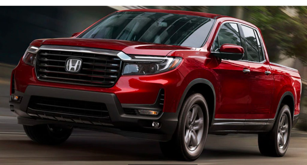 A red 2022 Honda Ridgeline is driving.