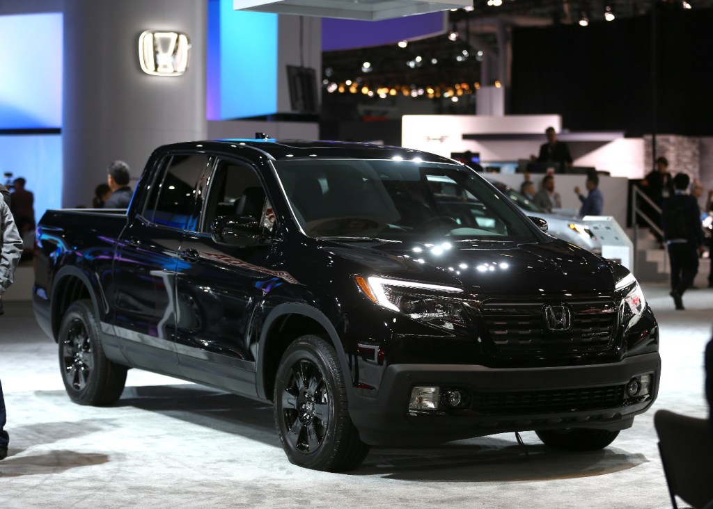 A Honda Ridgeline mid-size truck is featured at an auto show.