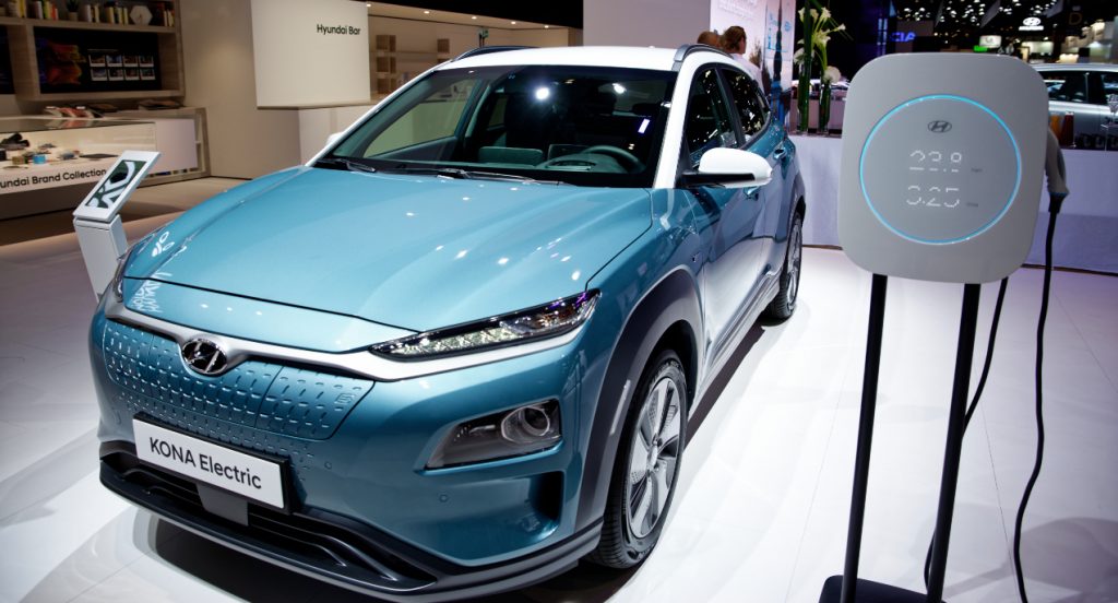 A blue Hyundai Kona Electric subcompact SUV is on display.