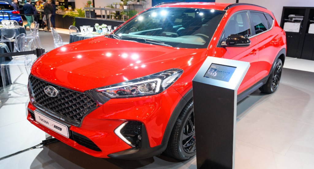A red Hyundai Tucson is on display.