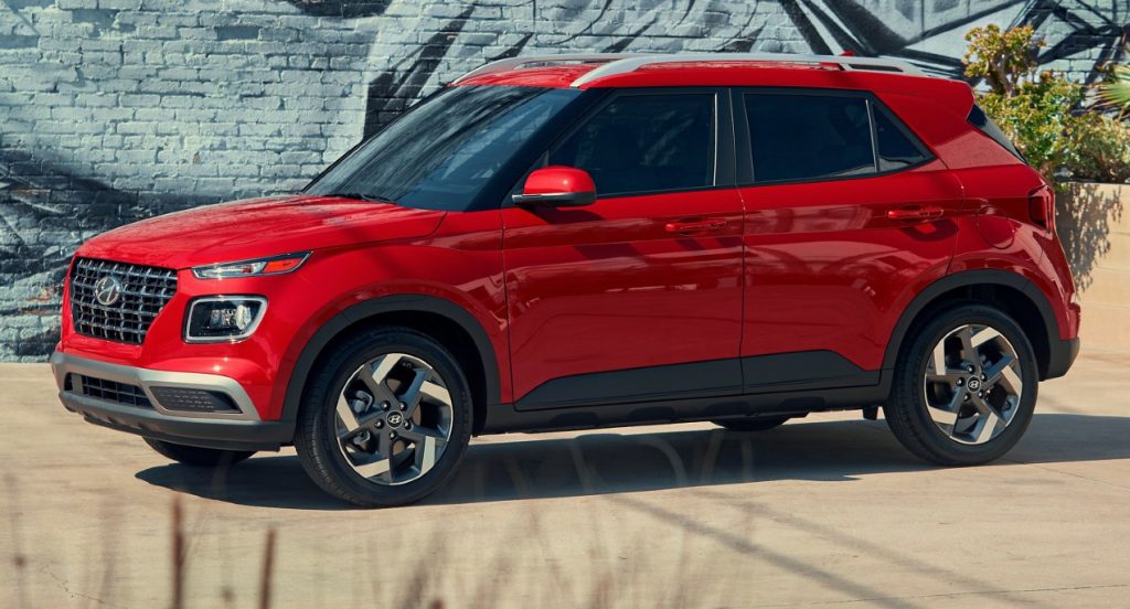 A red Hyundai Venue Limited subcompact SUV is parked. 