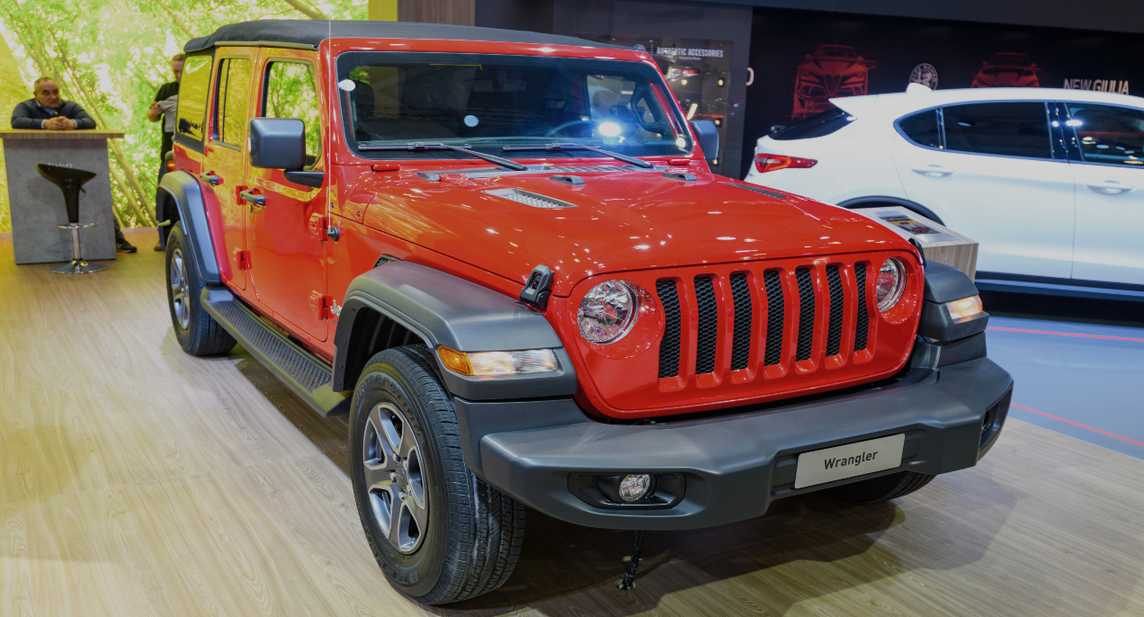 A red Jeep Wrangler is on display.