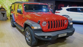 A red Jeep Wrangler is on display.