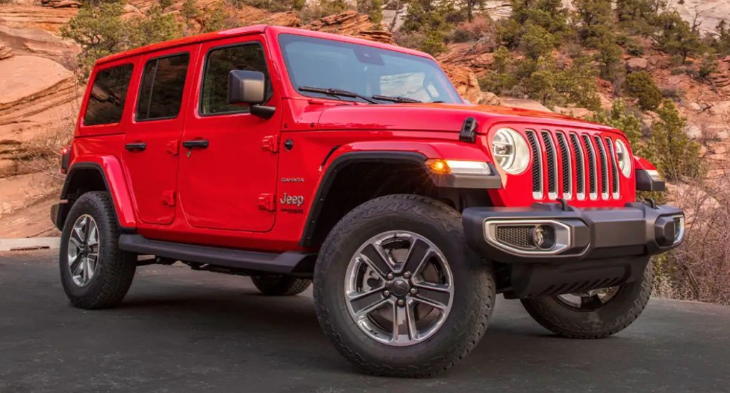 A red Jeep Wrangler compact SUV.