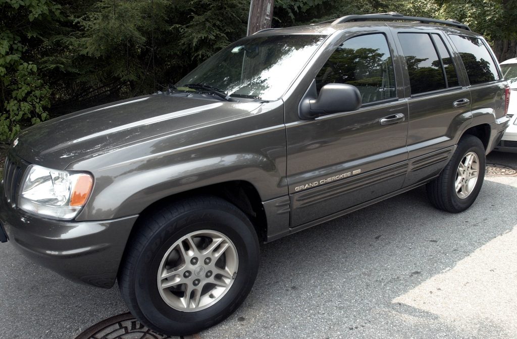 A Jeep Grand Cherokee SUV parked on the street.