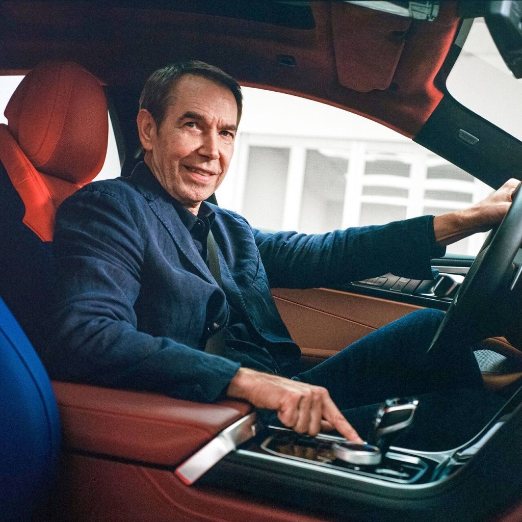 Jeff Koons sitting in the new BMW 8 Series Art Car