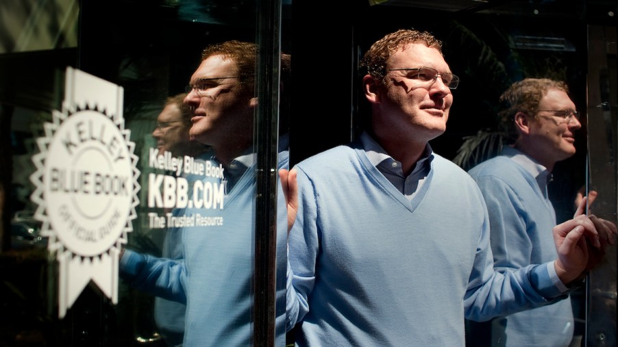 Kelley Blue Book president Jared Rowe stands next to the KBB logo on April 3, 2013, in Irvine, California