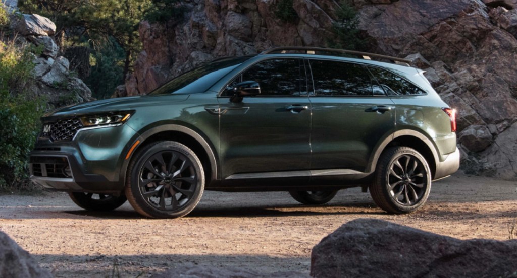 A green Kia Sorento is parked outdoors.