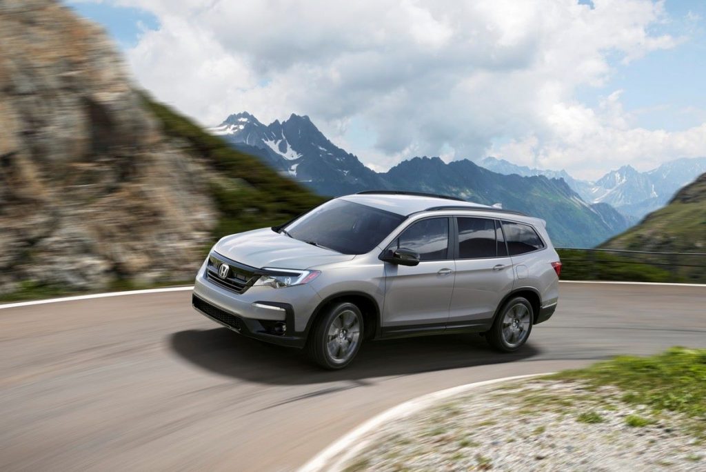 Lunar Silver Metallic 2022 Honda Pilot driving on a mountain road