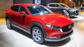 A red Mazda CX-30 subcompact SUV is on display.
