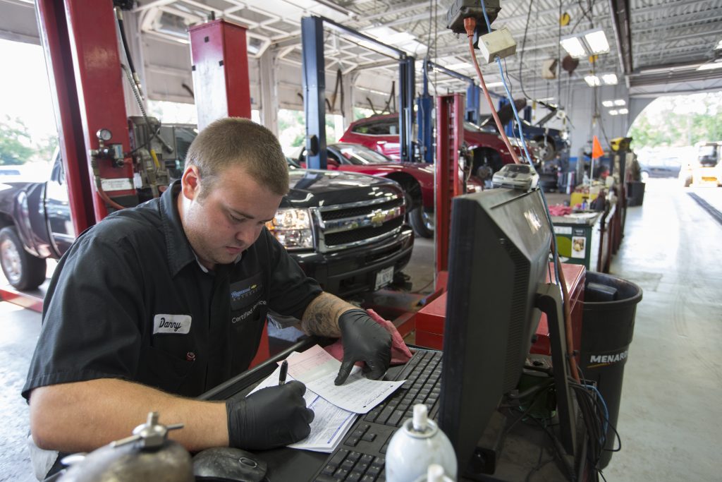 mechanic filling out paperwork