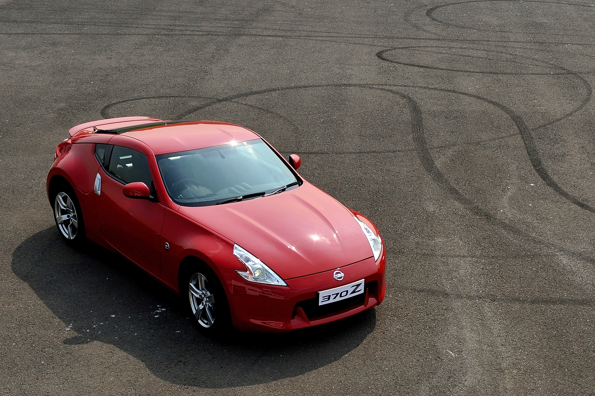A red Nissan 370Z shot from above on tarmac