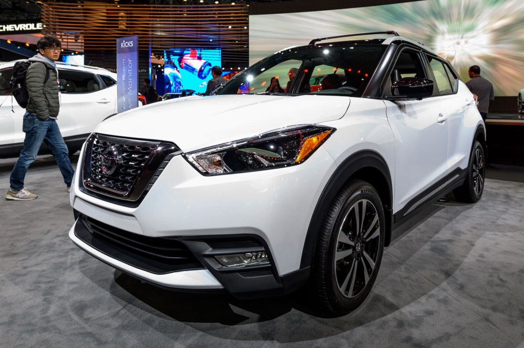 A white Nissan Kicks parked indoors.