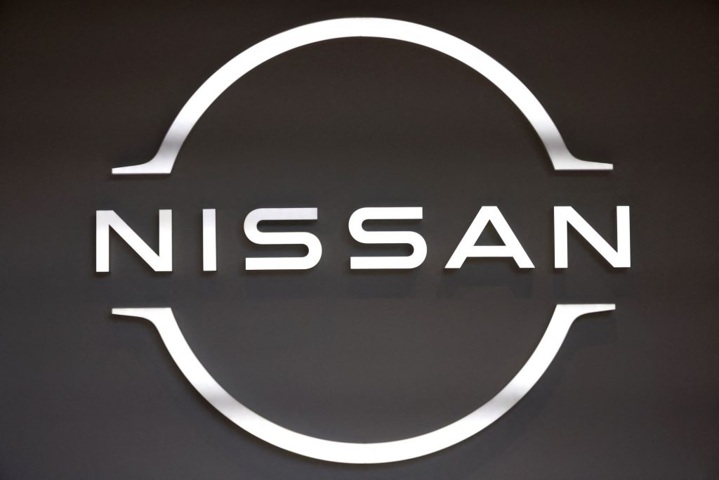 A white Nissan logo, maker of the Nissan Z series, on a black background. 
