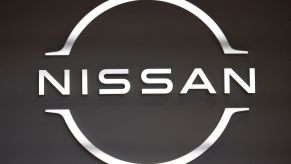 A white Nissan logo, maker of the Nissan Z series, on a black background.