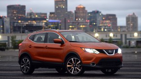 The Nissan Rogue sets in front of a city scape.