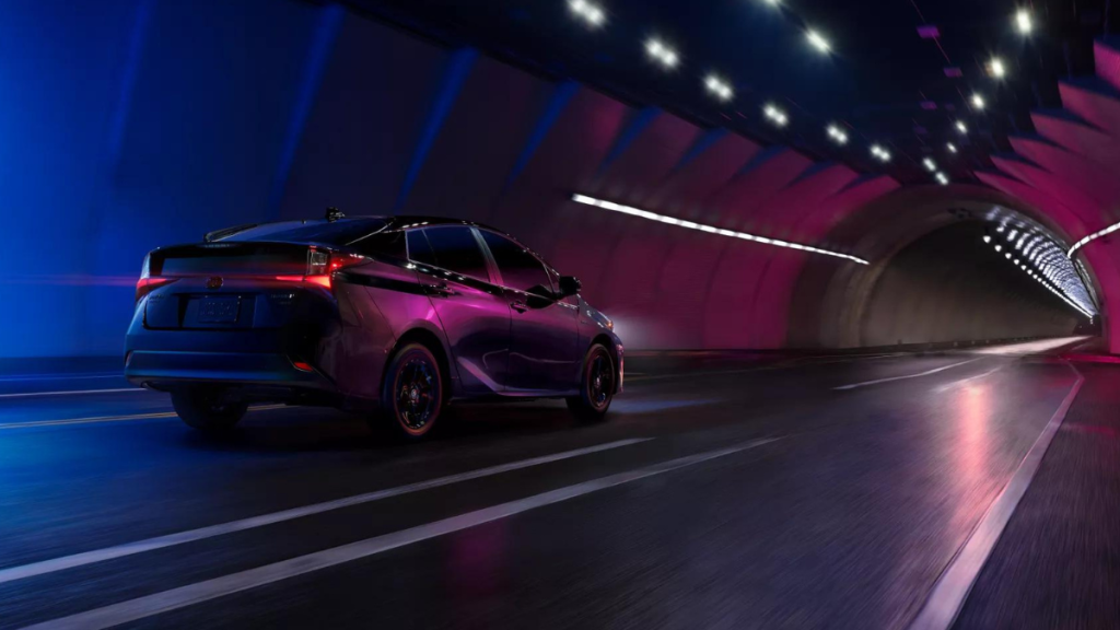 Purple 2022 Toyota Prius driving through a tunnel, highlighting reasons to buy a hybrid car in 2022