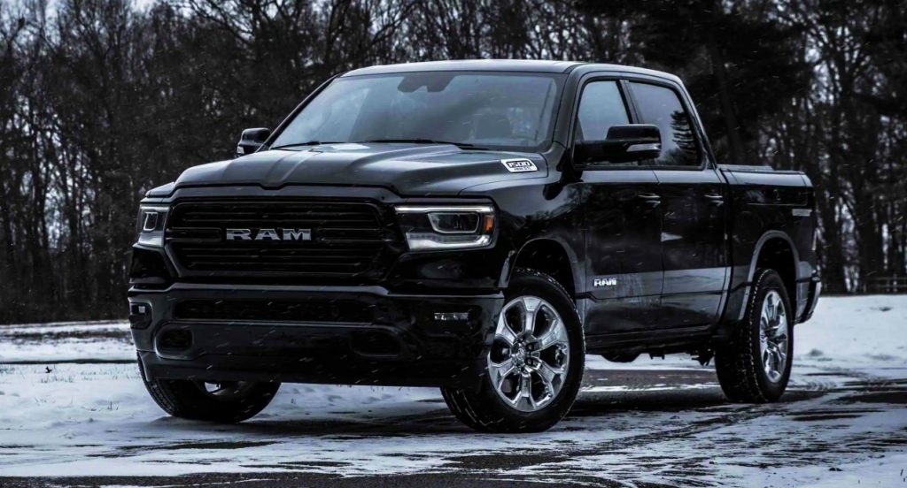 A black Ram 1500 is parked outside. 