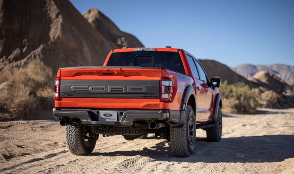 Rear view of orange 2022 Ford F-150 Raptor, highlighting release date of 2022 Ford F-150 Raptor R