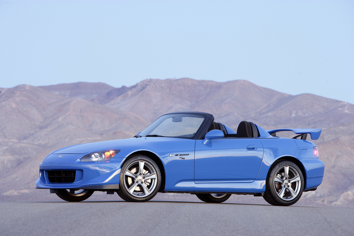 Driver Side of Blue 2009 Honda S2000 CR Convertible Club Racer with Top Down in front of a mountain range