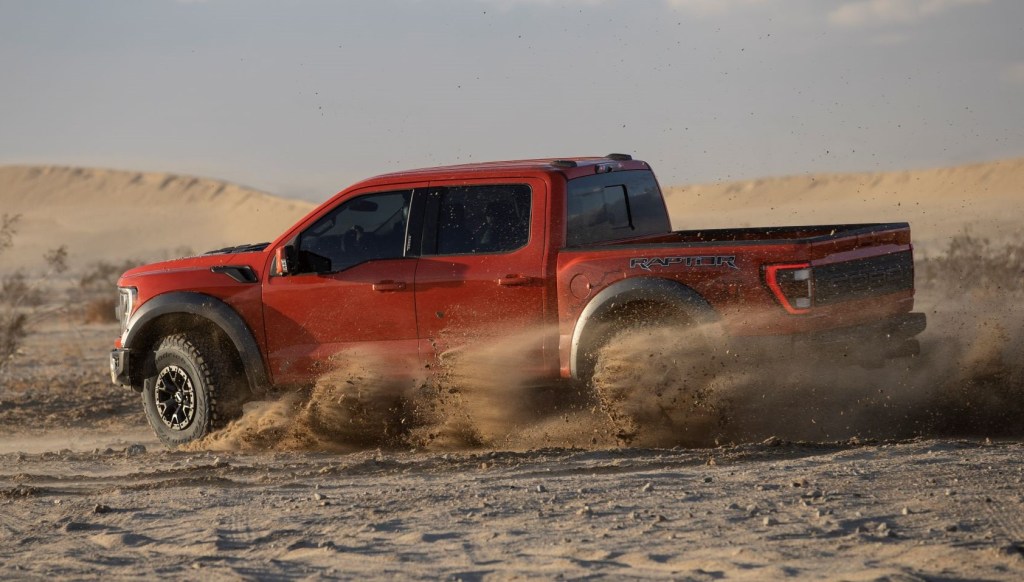 Side view of orange 2022 Ford F-150 Raptor, highlighting release date of 2022 Ford F-150 Raptor R