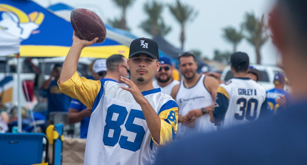 Jerrod Gomez of Paramount plays catch while tailgating before the Rams vs. Chargers game at SoFi Stadium.
