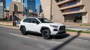Super White 2022 Toyota RAV4 driving on a city street