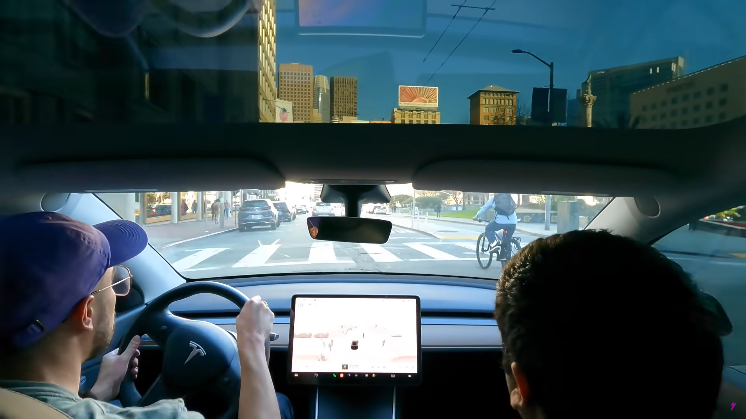 The moment before a Tesla Model 3 nearly hit a cyclist in downtown San Francisco