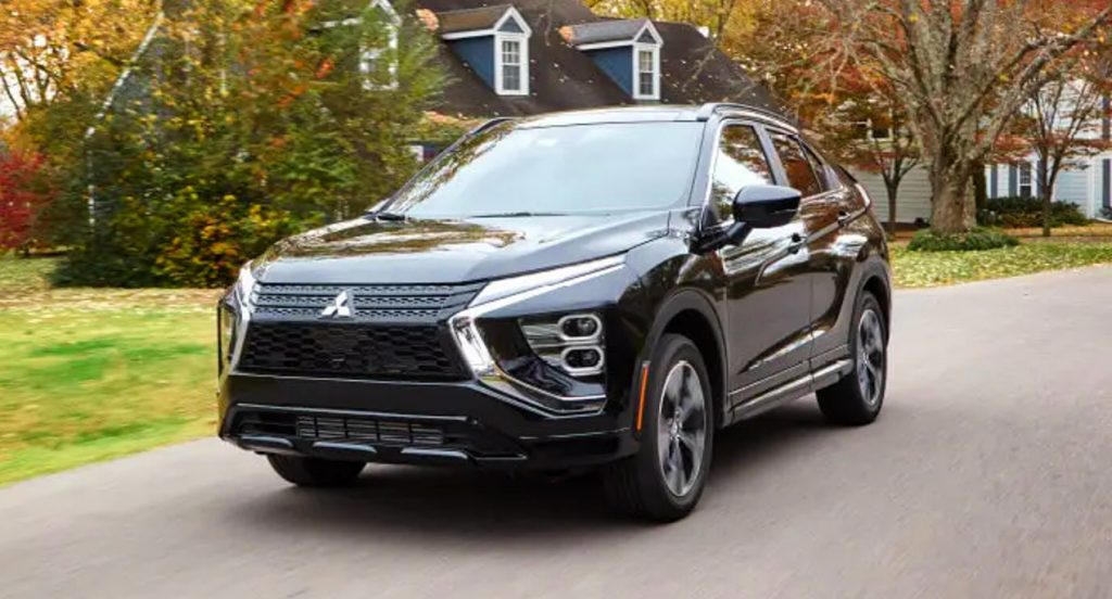 A black 2022 Mitsubishi Eclipse Cross is driving on the road. 