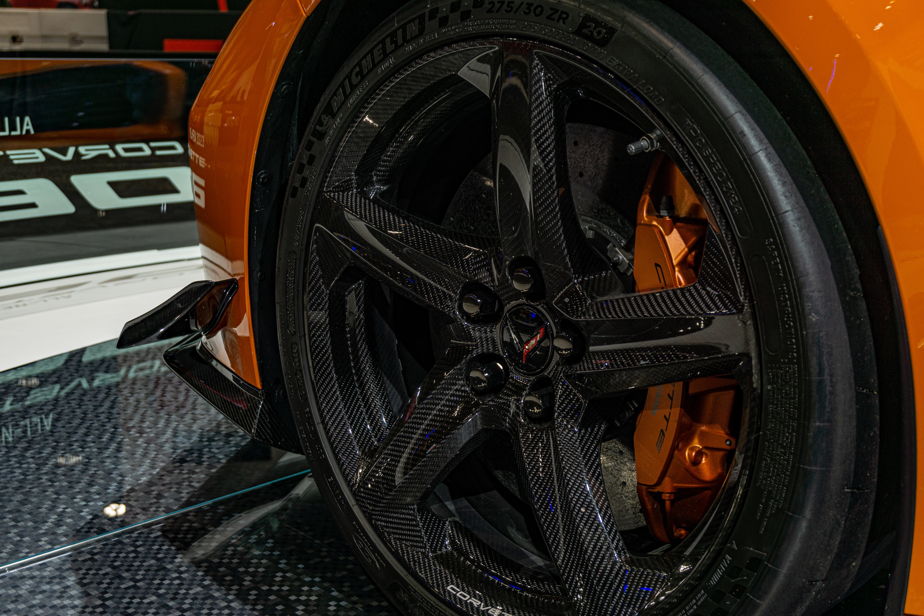 An orange 2023 C8 Chevrolet Corvette Z06 Convertible with Z07 Package's carbon-fiber wheel and dive planes