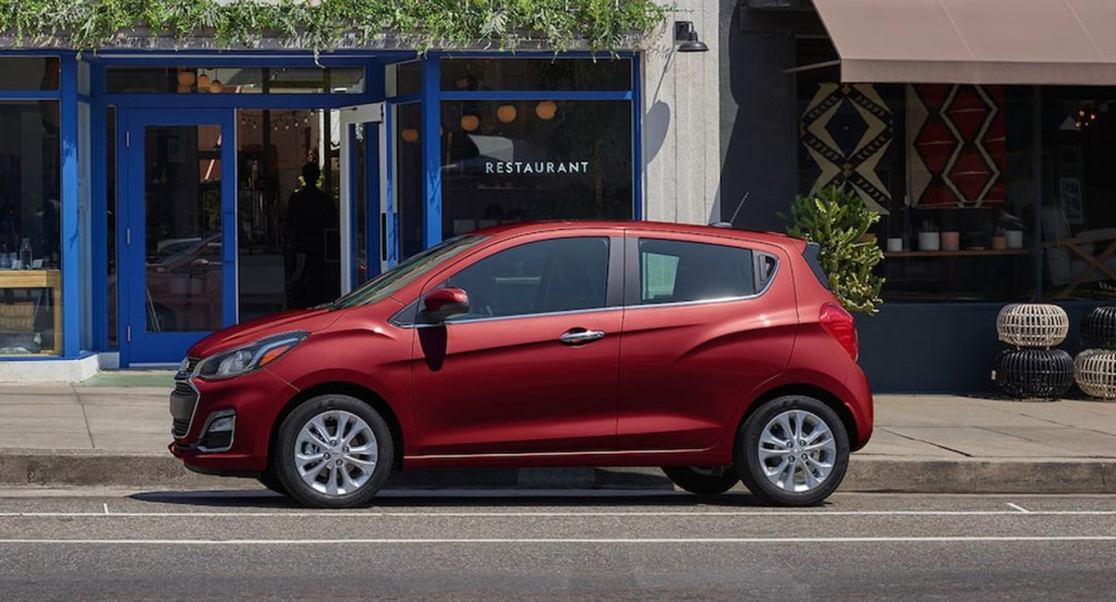 A red Chevy Spark small car is parked.