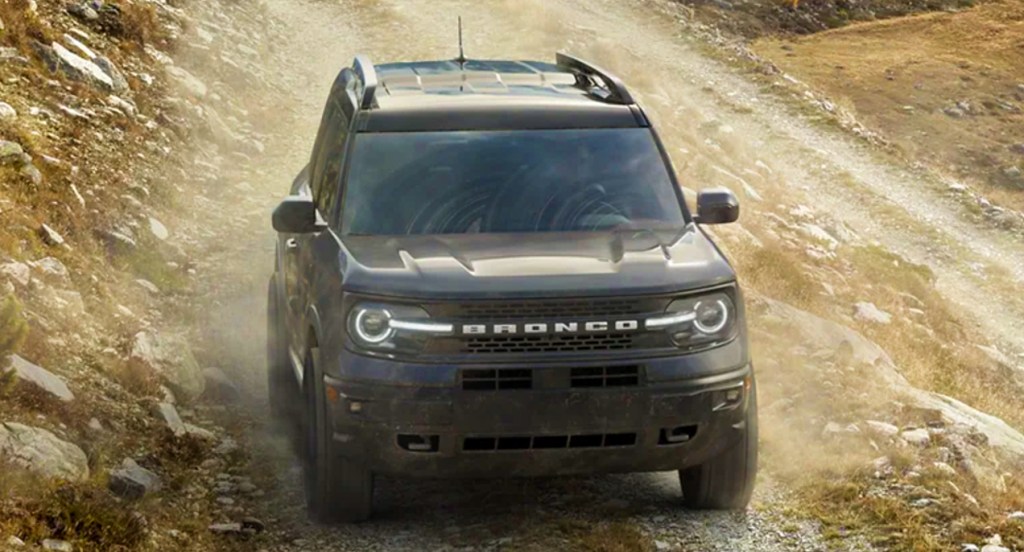 A black Ford Bronco Sport small SUV is driving off-road. 