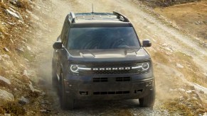 A black 2022 Ford Bronco Sport is driving off-road.