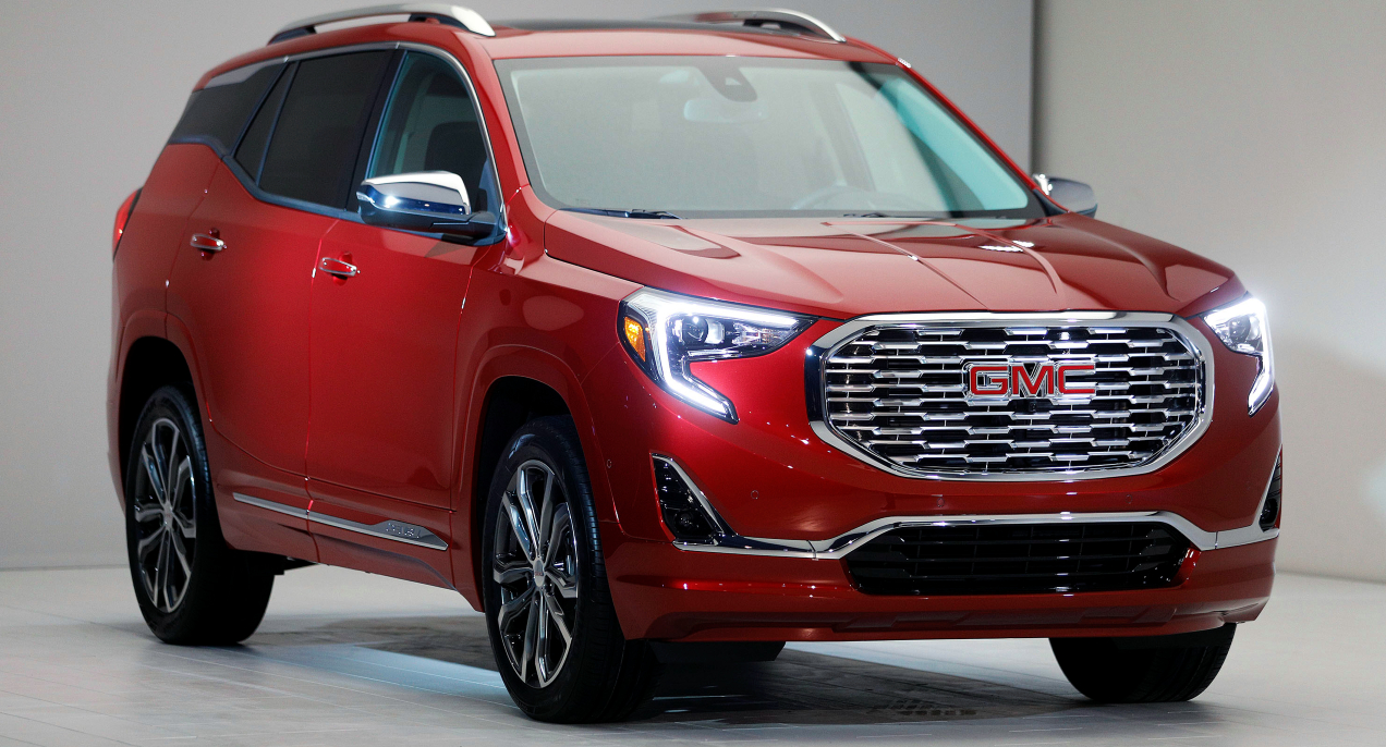 A red GMC Terrain small SUV is on display.