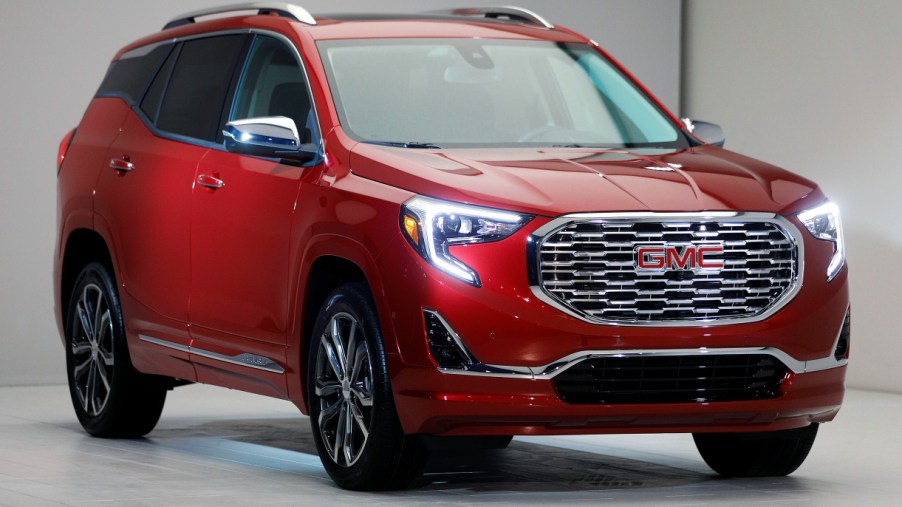 A red GMC Terrain small SUV is on display.
