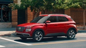 A red Hyundai Venue Limited is at a stop light.