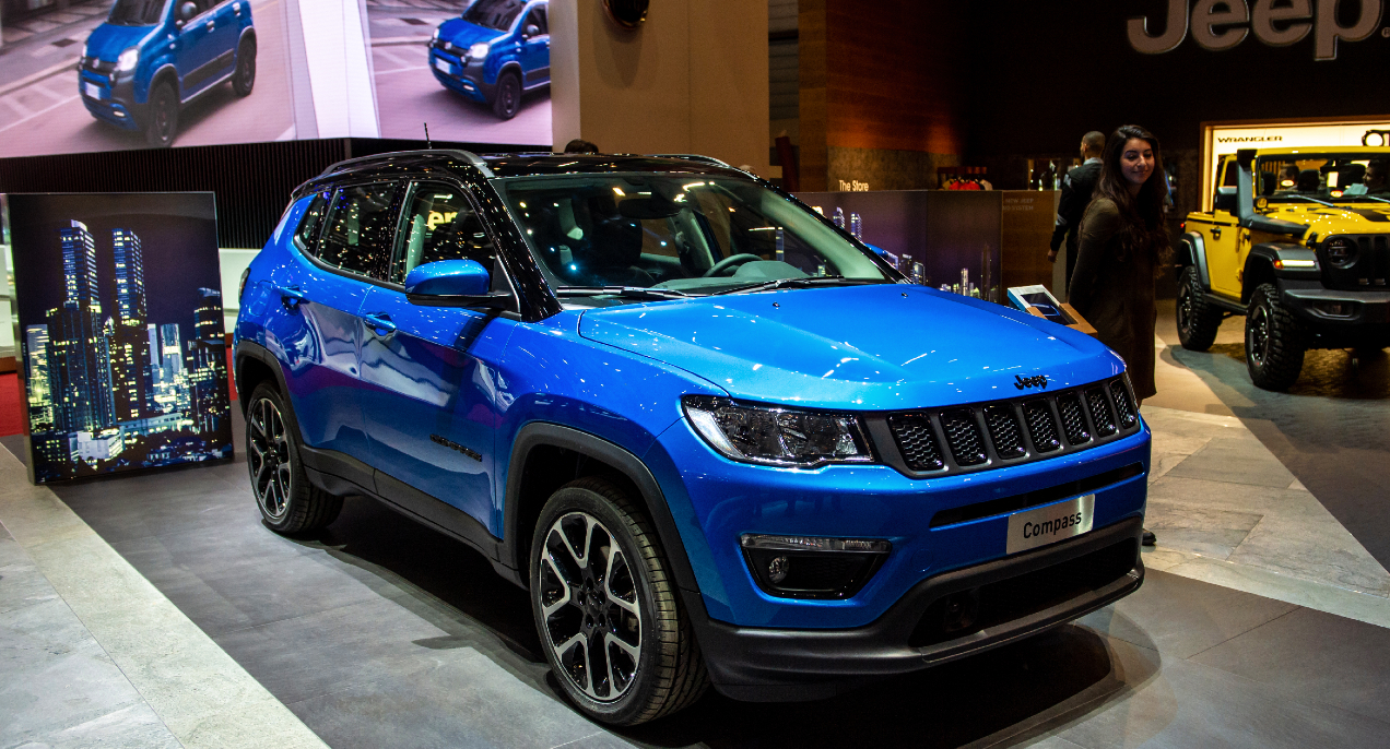 A blue Jeep Compass compact SUV is on display.