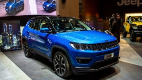 A blue Jeep Compass compact SUV is on display.
