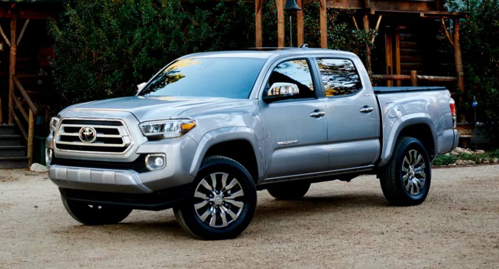 A gray Toyota Tacoma midsize truck is parked. 