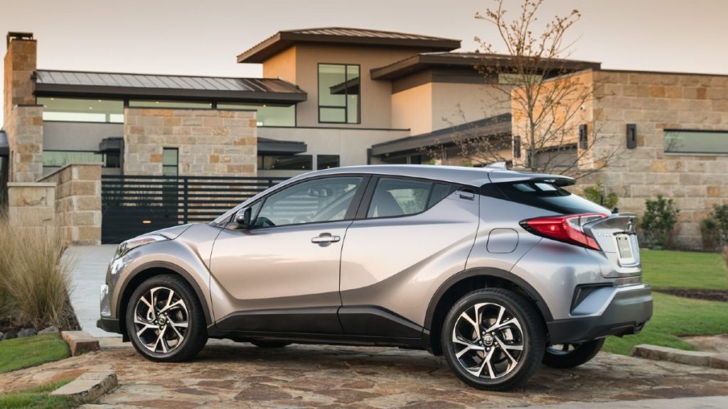 Toyota C-HR next to a large home