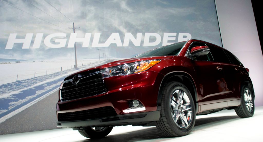 A red Toyota Highlander midsize SUV is on display. 