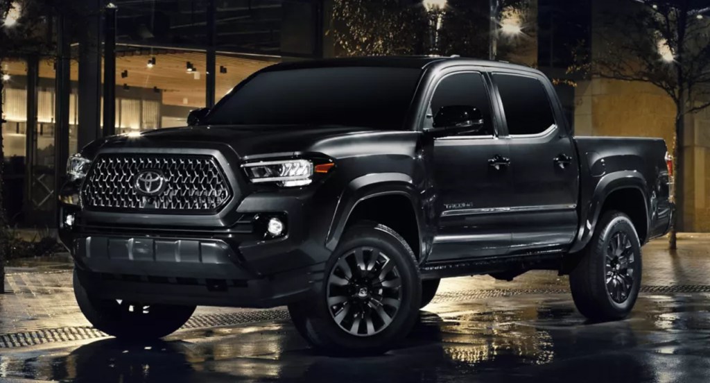 A black Toyota Tacoma midsize truck is parked. 