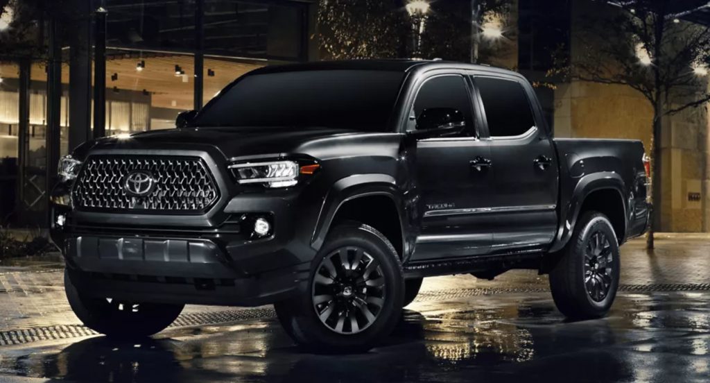 A black Toyota Tacoma is parked. 