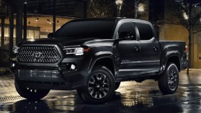 A black Toyota Tacoma is parked.
