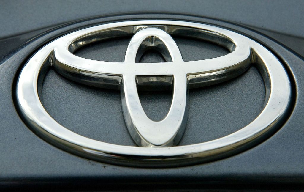 A silver Toyota logo on a black background.