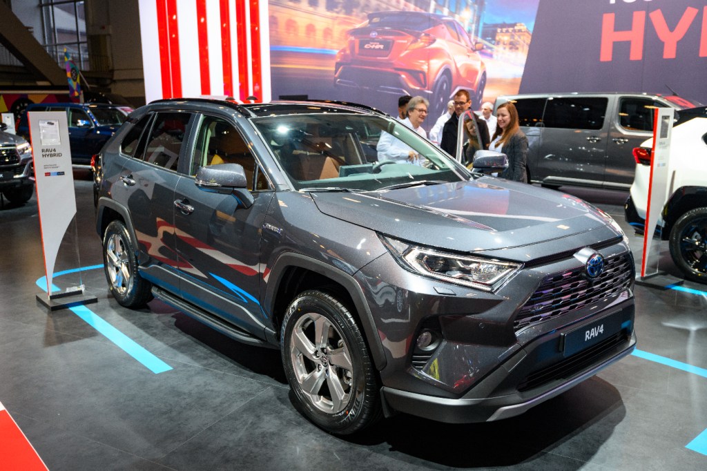 A Toyota RAV4 Hybrid SUV is displayed at an auto show.