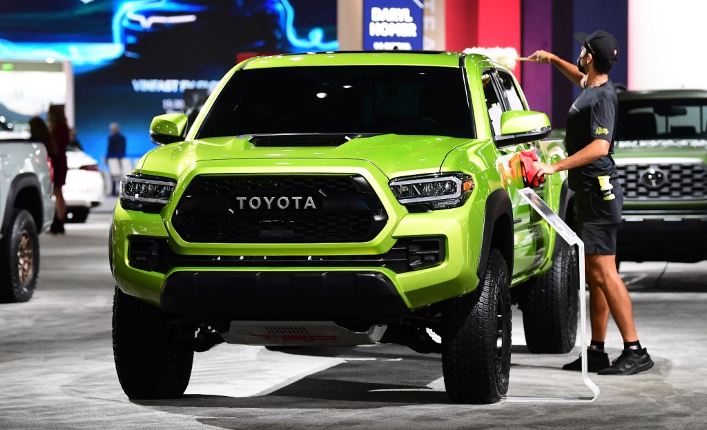 A Toyota Tacoma mid-size truck sits on the showroom floor.