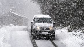 A vehicle driving in the snow, potentially AWD or 4WD.